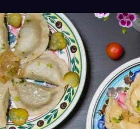Meat pierogi with onion and cucumber