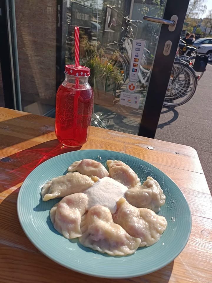 Sweet pierogi with cream and kompot